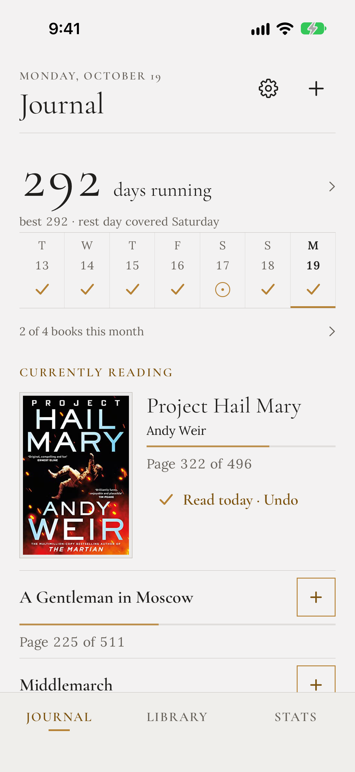 The Journal screen: a running streak, the week's reading days, and the three books currently being read, the first marked as read today.